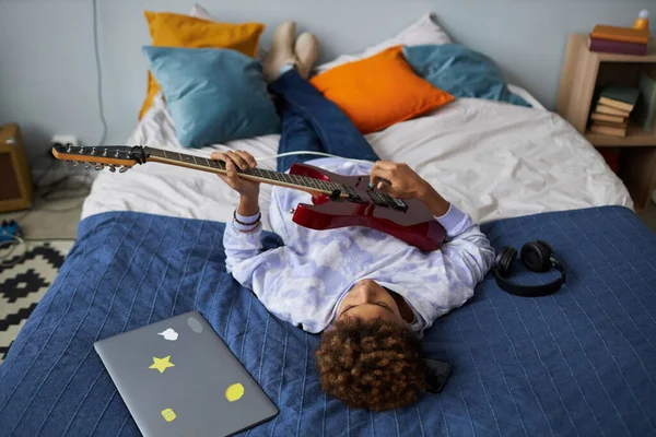 Restful African American Teenage Boy Playing Electric Guitar While Relaxing — Stock Photo, Image