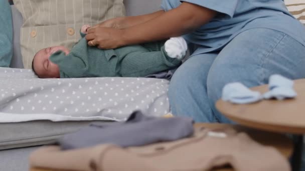 Tiro Cortado Mãe Colocando Abotoando Casaco Malha Bebê Filho Deitado — Vídeo de Stock