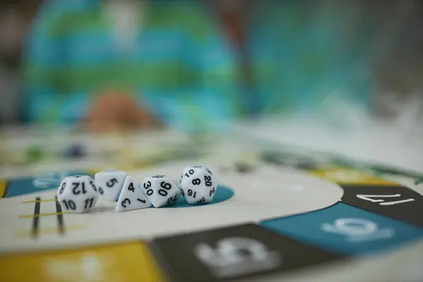 Background image of board game with macro closeup of multi sided dice set, copy space