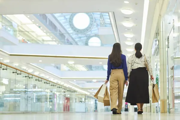 Back View Two Women Walking Away Camera Shopping Mall Holding — Stock Photo, Image