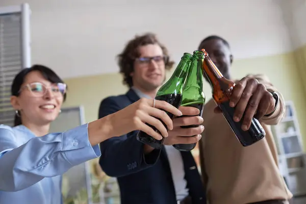 Closeup Colleagues Clinking Beer Bottles While Celebrating Office Workplace Party — Stock Photo, Image