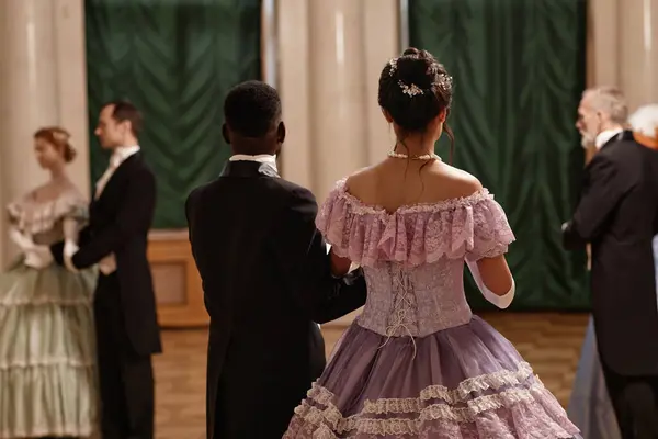 stock image Back view of classic lady and gentleman entering ballroom in palace, copy space