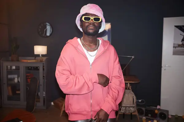 stock image Waist up portrait of Black young man wearing pink outfit hip-hop style and looking at camera with flash copy space