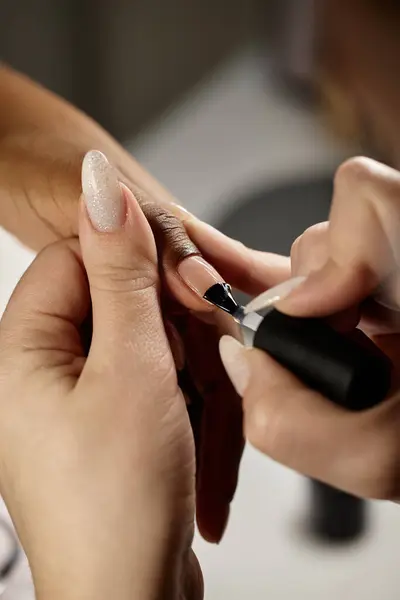 stock image Vertical close up on manicurist hands covering clients nails with the transparent polish, copy space