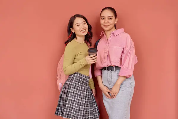 stock image Portrait shot of two smiling multiethnic female students wearing colorful preppy outfits