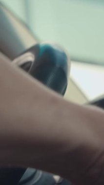 Araba kullanırken direksiyonda tanınmayan bir adamın dikey çekimleri.