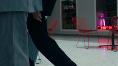 Kafkas ofis çifti resmi iş kıyafetlerinde modern kapalı ofis alanlarında dans ediyorlar.