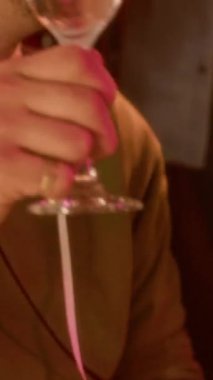 Dikey olarak, çeşitli genç arkadaşlarımızın kadehlerini tokuşturup şampanya içerek, parlak folyo perdelerine karşı durarak ve birlikte vakit geçirerek...