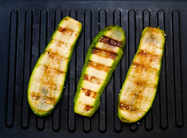 Spicy zucchini cooked on electric grill. Cooking delicious food at home. Creative copy space
