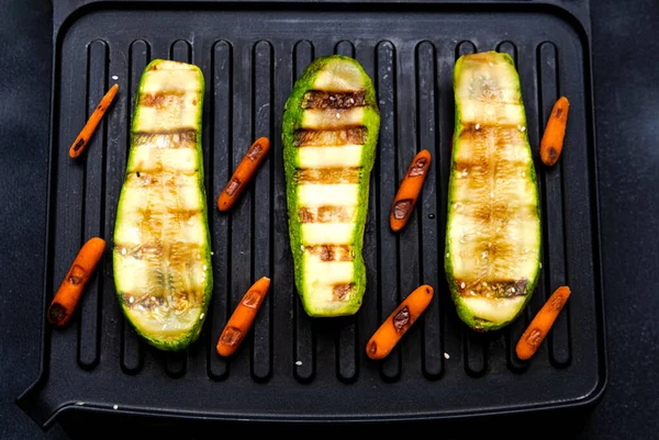 Grilled zucchini and carrots. Cooking delicious food at home on electric grill.