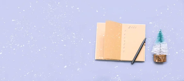 Goals in notebook for 2023 on blue background with sparkles . Festive concept. Atmospheric mood in trendy colors of the New Year.