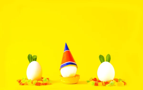 Easter eggs on yellow background. Happy Easter concept. Bold hues for seasonal projects. Copy space
