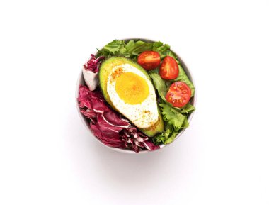 Baked egg with avocado. Bowl from healthy and balanced products. Fodmap diet concept. Close-up clipart