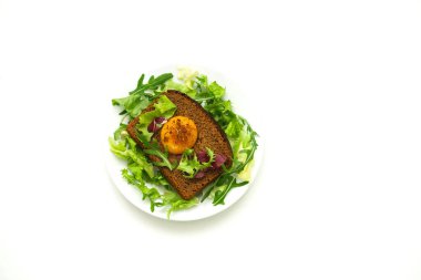 Rye bread sandwich with lettuce and egg yolk. Homemade food. Healthy sandwich. 
