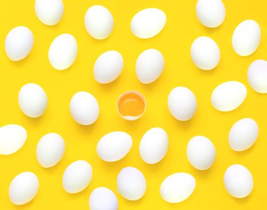 Pattern from chicken white eggs,yolk and half eggs iyellow background. Concept of foods rich in vitamin D or ingredient for baking. 