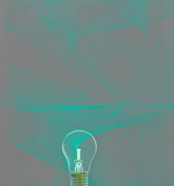 Turned off light bulb on green background with hologram. The concept of energy saving or environmental protection.