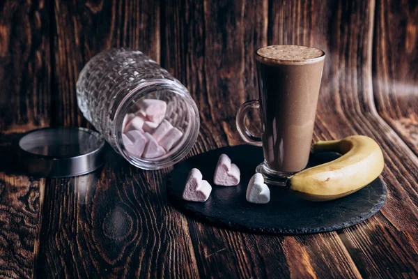 Milk coffee cocktail with banana smoothie in glass. Healthy vegan food. frozen fruit