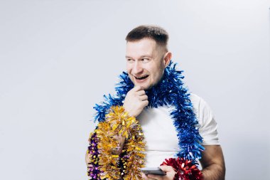 Man in white t-shirt and christmas decorations celebrating new year
