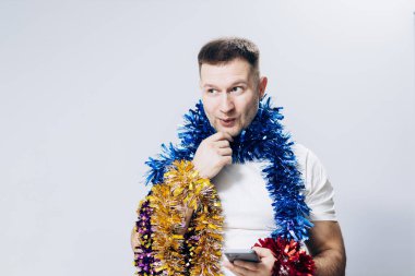 Man in white t-shirt and christmas decorations celebrating new year