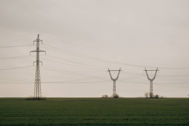 City power supply. Electricity flows through wires. High voltage towers in field