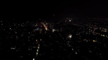 The night city celebrates the new year. December 31, New Year's Eve, fireworks explode over the houses. High quality FullHD footage