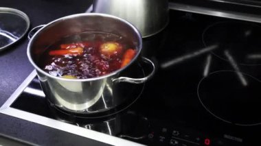 Water boils in steel pot and vegetables are boiled for salad