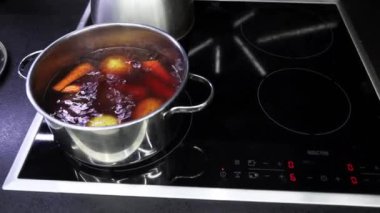 Water boils in steel pot and vegetables are boiled for salad