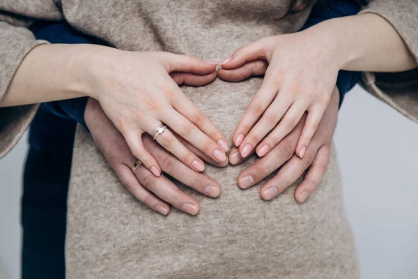 Appearance of firstborn. First birth. Pregnancy. Hands rest on pregnant belly
