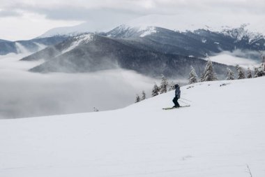 01.12.23 Ukraine, Dragobrat People go snowboarding and skiing from snowy mountains. Snow boarding in winter