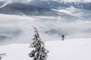 01.12.23 Ukraine, Dragobrat People go snowboarding and skiing from snowy mountains. Snow boarding in winter