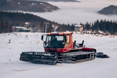 Dragobrat, Ukraine mountain landscape with fog and fir trees. Dawn in a snowy ski resort