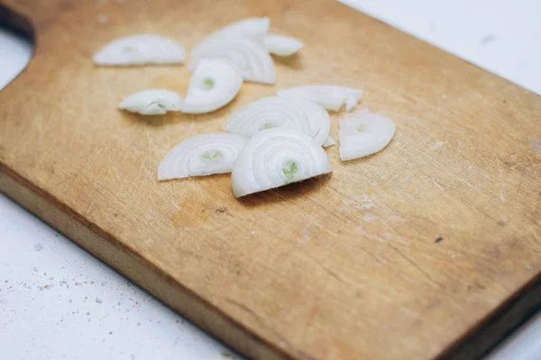 stock image Onion finely chopped into slices on wooden board