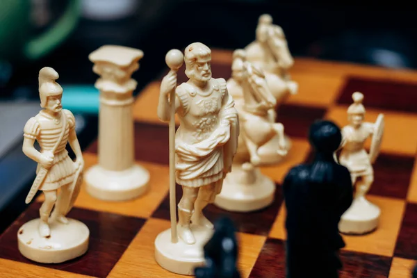 stock image Chess pieces are on board. Queen and king in chess are in difficult situation