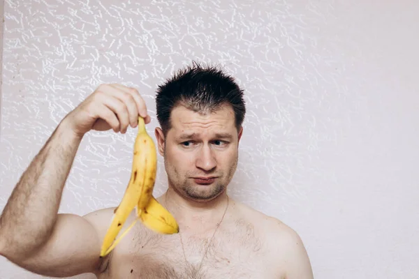 stock image Guy without clothes holds a missing banana in his hand. Erection problem, male health