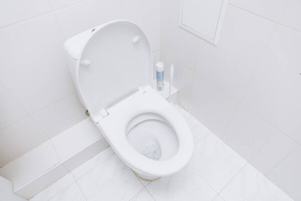 White toilet with open lid. Toilet morning procedures