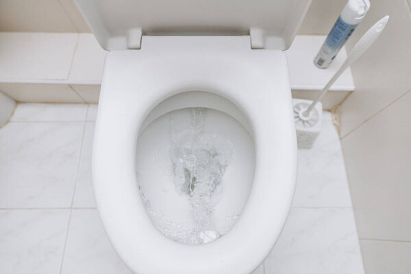 White toilet with open lid. Toilet morning procedures