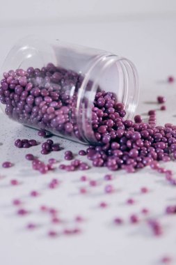 Masanın üzerine granül şeklinde mor kaş cilası saçılmış. Kozmetoloji, kaş uzmanı.