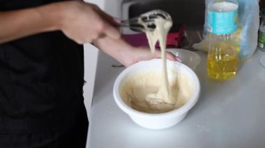 Manis hamur yoğuruyor, kendi başına lezzetli ve yumuşak ev yapımı ekmek hazırlıyor. Mutfakta taze, el yapımı ekmek pişiriyor..