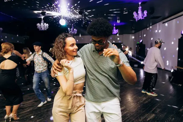 Kharkiv, Ukrayna 15.05.24 kişi bir kulüpte salsa dansı yapıyor. Parlak ışıkları olan bir gece kulübünde sosyal dans.