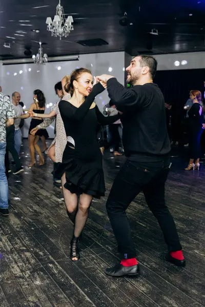Kharkiv, Ukrayna 15.05.24 kişi bir kulüpte salsa dansı yapıyor. Parlak ışıkları olan bir gece kulübünde sosyal dans.