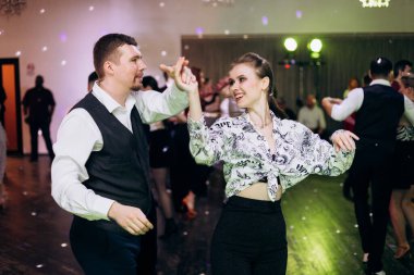 Kharkiv, Ukrayna 15.05.24 kişi bir kulüpte salsa dansı yapıyor. Parlak ışıkları olan bir gece kulübünde sosyal dans.