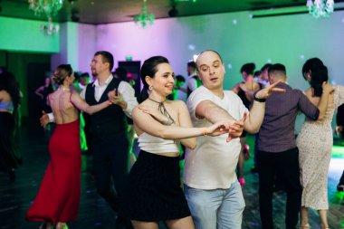Kharkiv, Ukrayna 15.05.24 kişi bir kulüpte salsa dansı yapıyor. Parlak ışıkları olan bir gece kulübünde sosyal dans.