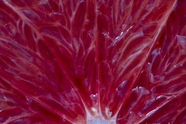 Close up of sliced ripe grapefruit, macro. Red fresh grapefruit surface background or texture. Top view