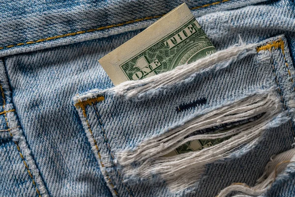 One dollar bill in the pocket of the jeans, close up