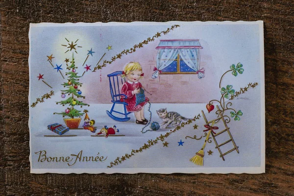 Old retro french postcard with the words Bonne Annee what is translated Happy New Year in French. French Christmas card from the seventies, top view