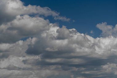 Güneşli bir günde mavi gökyüzünde yüzen doğal gün ışığı ve beyaz bulutlar. Mavi gökyüzü arka planında beyaz bulutlar. Doğa konsepti