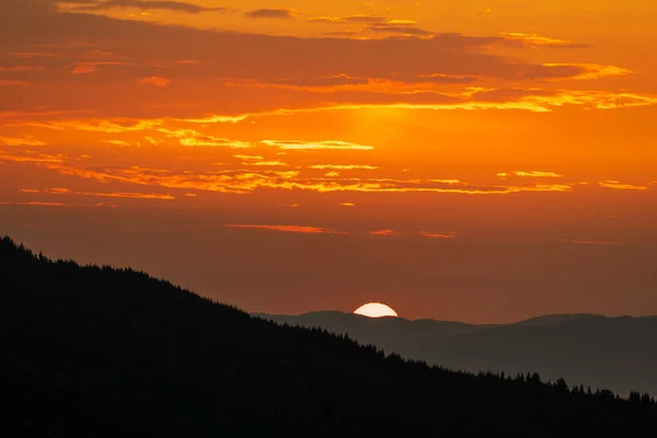 The morning sun rises over the Carpathian mountains in the summer, Ukraine, Europe. Nature and environment concept. Beautiful sunrise in the mountains