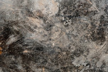 Grunge old black metal background or texture with scratches and cracks, close up, top view