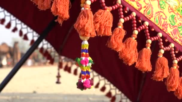 Decorative Ornaments Colored Threads Beads Hanging Umbrella Time Pushkar Camel — Stockvideo