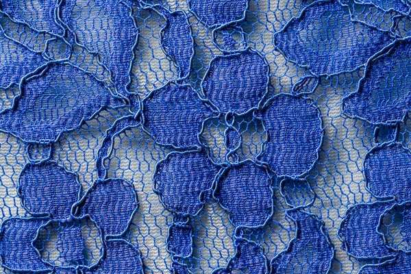 Detail of a blue women blouse made of guipure fabric, close up